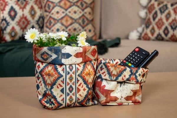 Set of fabric storage boxes with ethnic patterns, styled in a modern living room.