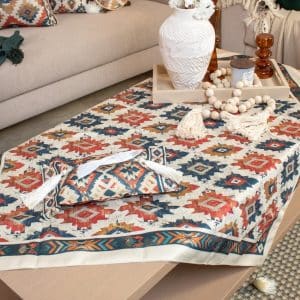 Square tablecloth with ethnic patterns styled on a coffee table.