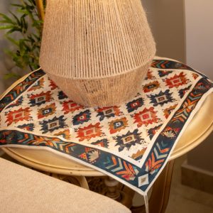 Ethnic-inspired double-sided table runner styled in a cozy living room setup.