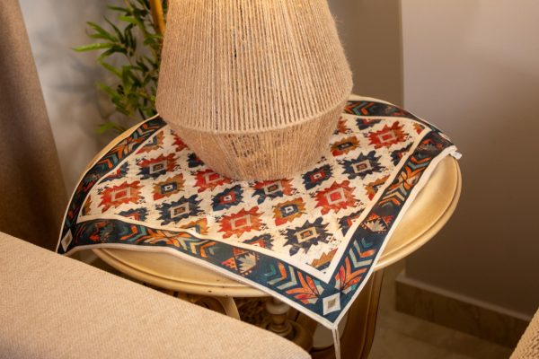 Ethnic-inspired double-sided table runner styled in a cozy living room setup.