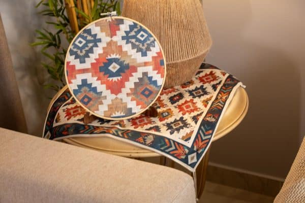 Set of wooden hoops with ethnic patterns styled as wall decor in a cozy living room.