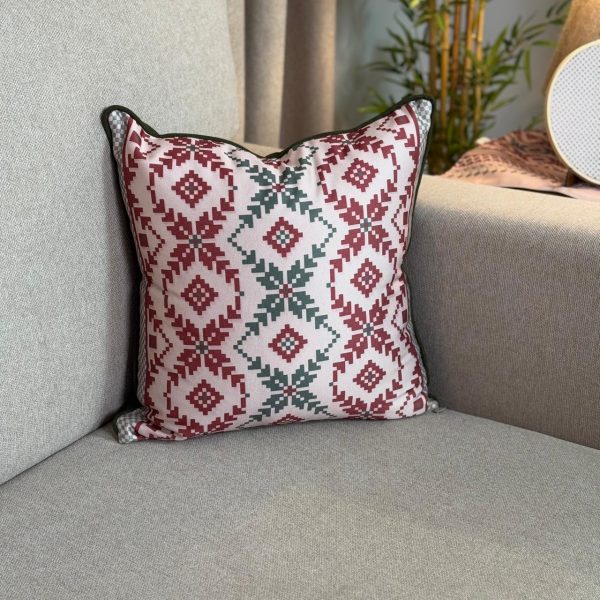 Baysan square cushion cover with traditional warm-toned patterns.