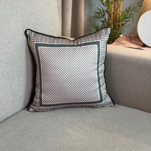 Baysan square cushion cover with traditional warm-toned patterns.