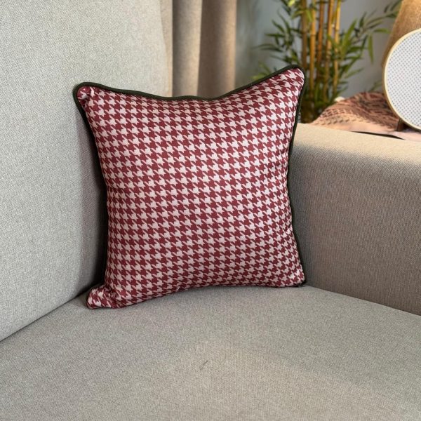 Baysan square cushion cover with traditional warm-toned patterns.