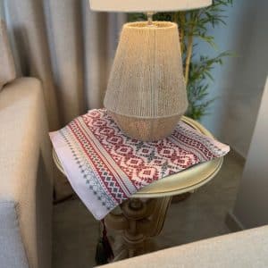 Baysan side table mat with intricate traditional patterns and tassels.