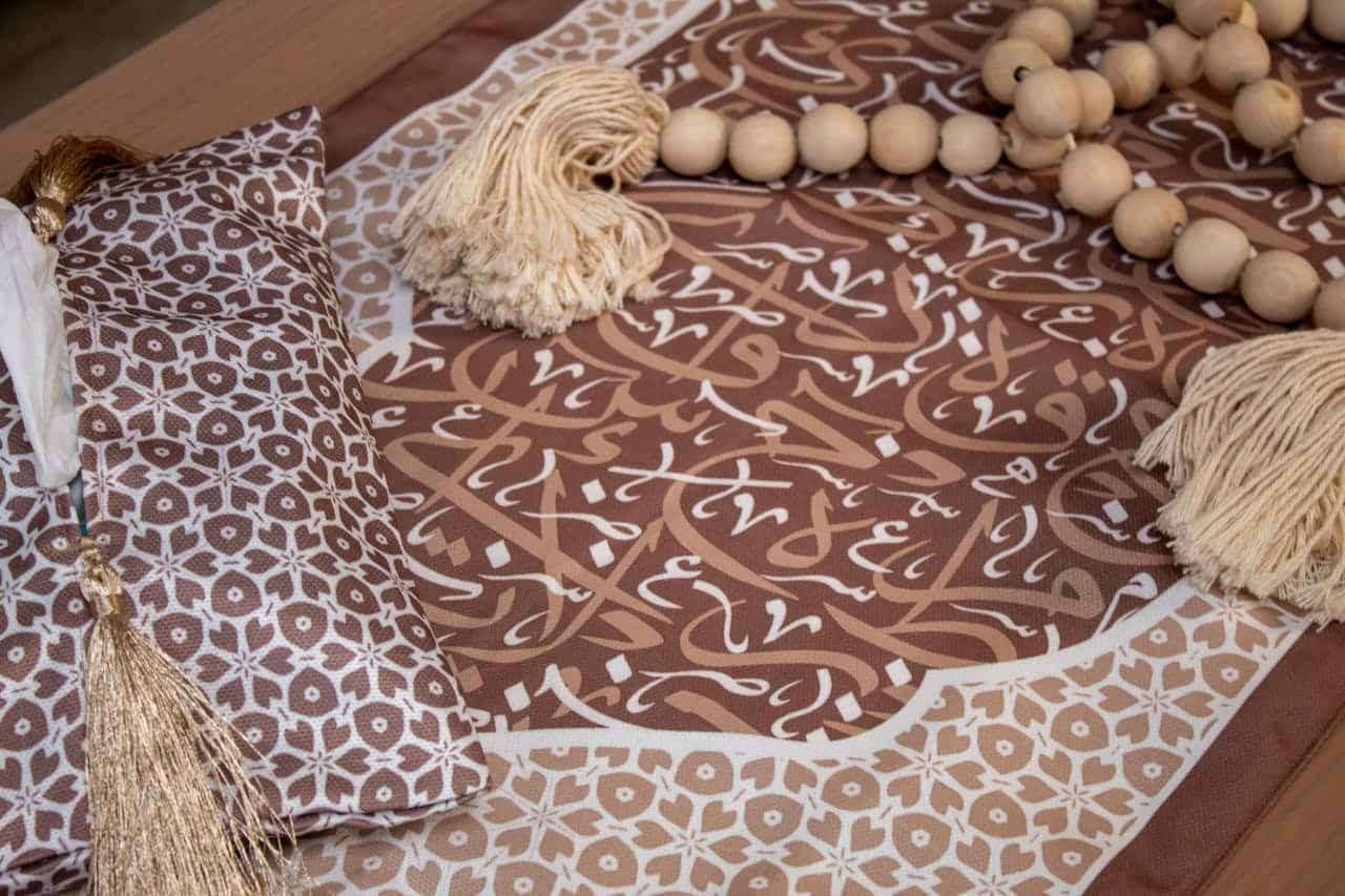 Double-Sided Ramadan Table Runner with Arabic Calligraphy – "أثر" Collection (Mocha 7 Double-sided table runner with Arabic calligraphy and tassels from the 'أثر' collection in mocha tones.