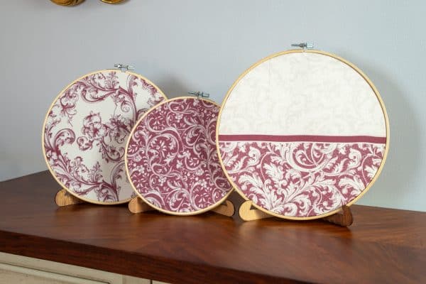 Set of burgundy decorative hoops displayed on a wall with matching decor accents.