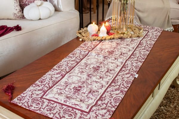 Luxurious burgundy dual-sided runner styled on a coffee table with candles and floral decor.