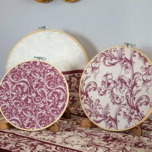 Set of burgundy decorative hoops displayed on a wall with matching decor accents.