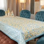 Dining table cover from the 'نقوش' collection with waterproof fabric and geometric patterns.