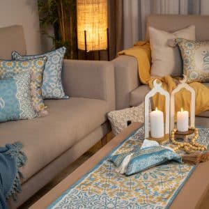 Double-sided table runner from the 'نقوش' collection with geometric patterns and tassels.