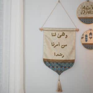 Wall hanging décor with geometric patterns, Arabic calligraphy, and tassels, part of the 'Namarq' Ramadan collection.