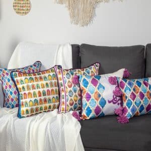 Decorative cushions with vibrant abstract designs from the 'طيف' collection.
