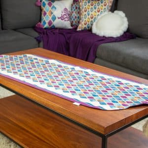 Double-sided table runner with colorful abstract patterns from the 'طيف' collection.