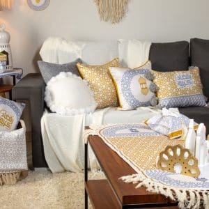 Decorative cushions with mustard and grey minaret motifs from the 'مآذن' collection.