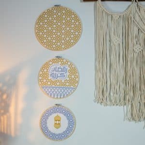 Wooden embroidery hoop set with mustard and grey minaret motifs from the 'مآذن' collection.