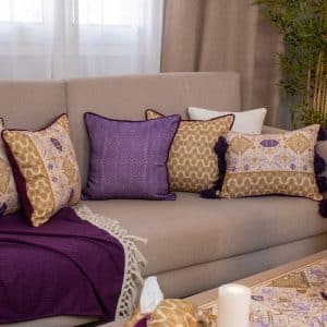 Decorative cushions with geometric ethnic patterns from the 'كناريا' collection.